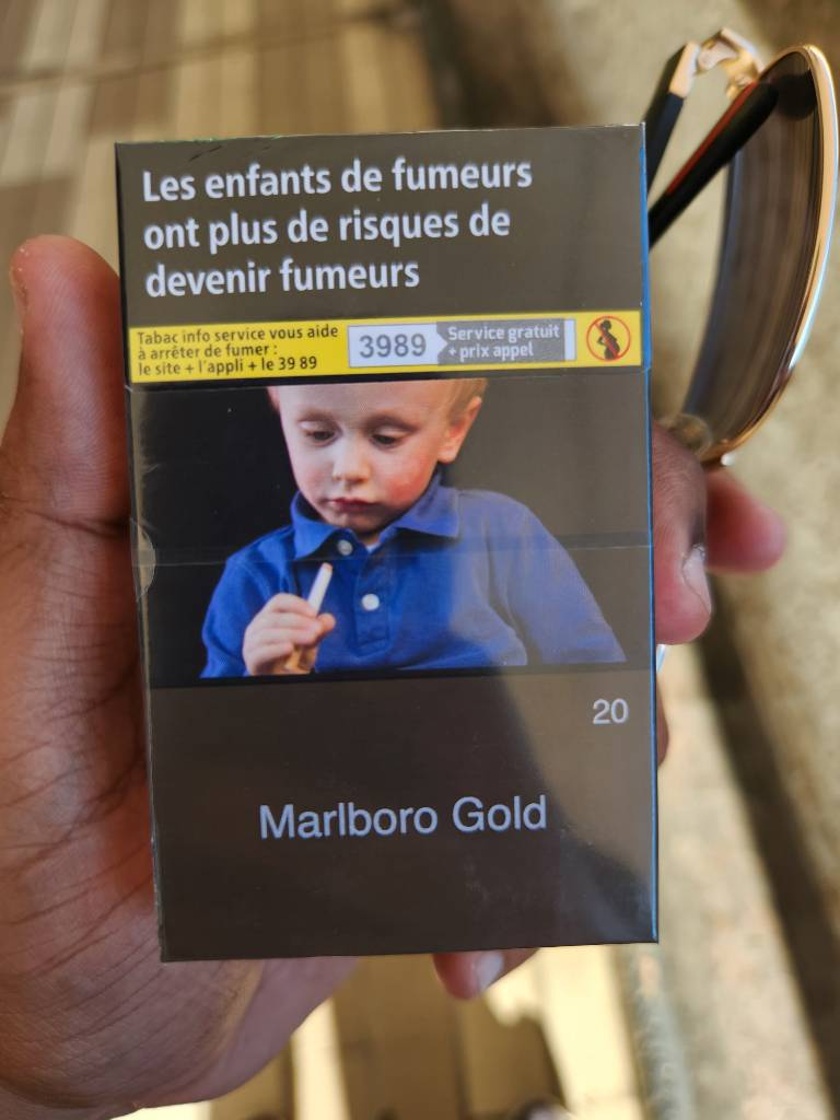 Child inspecting cigarettes.
