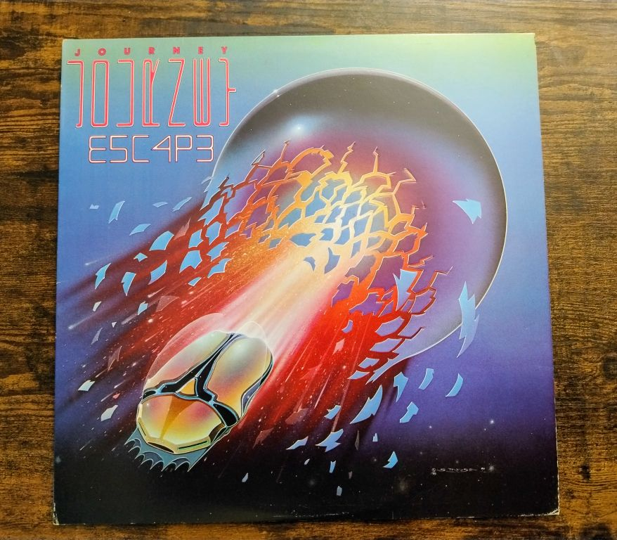 Cover of Journey's "Escape" album with the weird little gold insect launching from an orb.