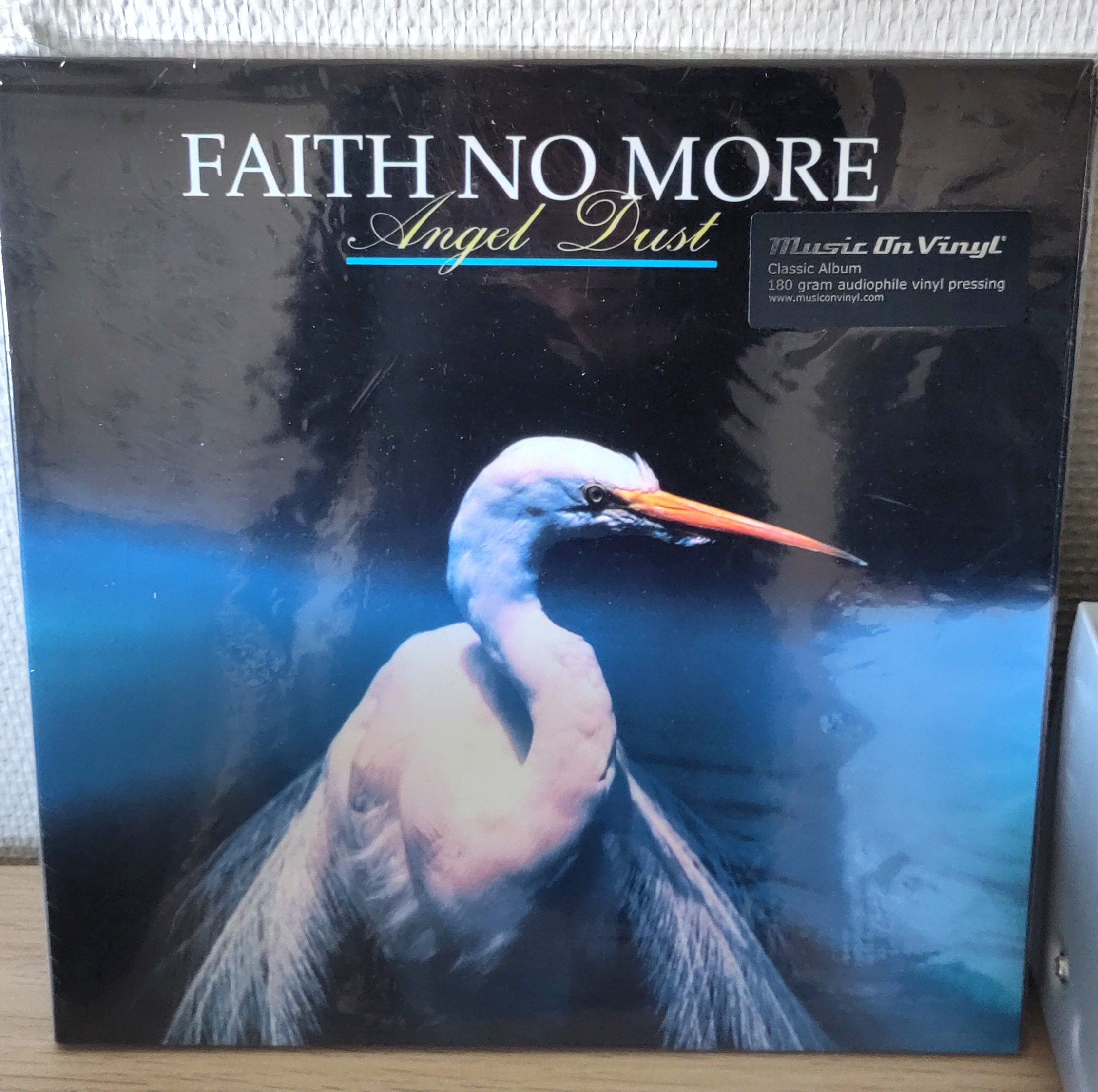 The cover of "Angel dust" is a white crane against a black and blue background. The bird looks really pissed, or maybe that just birds in general.
