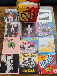 The Clash "The Singles" boxed set with a number of the discs spread, showing how each one is packaged like the original 45