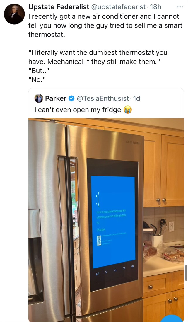 A joke tweet with an attached image of a smart refrigerator. The refrigerator displays a blue screen of death. The tweet reads “I can’t even open my fridge.” Another tweet is replying to it, taking it seriously and indicating they do not embrace smart technology.