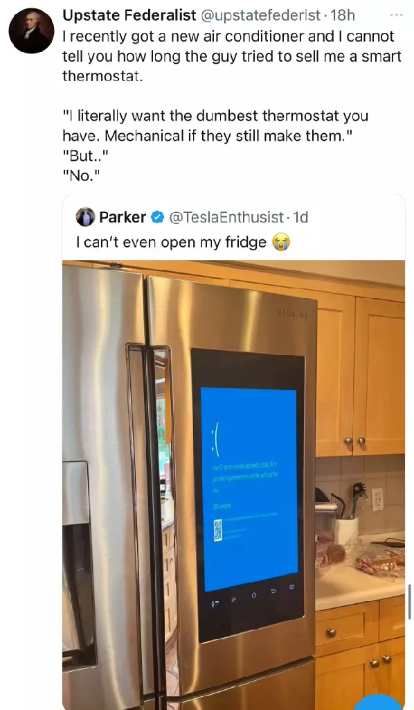 A joke tweet with an attached image of a smart refrigerator. The refrigerator displays a blue screen of death. The tweet reads “I can’t even open my fridge.” Another tweet is replying to it, taking it seriously and indicating they do not embrace smart technology.