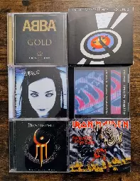 Group of varied CDs - ABBA Gold, Eagles Greatest Hits collection (volume 1 and 2), Evanescence Fallen, Moonspell Darkness and Hope, Nine Inch Nails Pretty Hate Machine, and Iron Maiden Number of the Beast