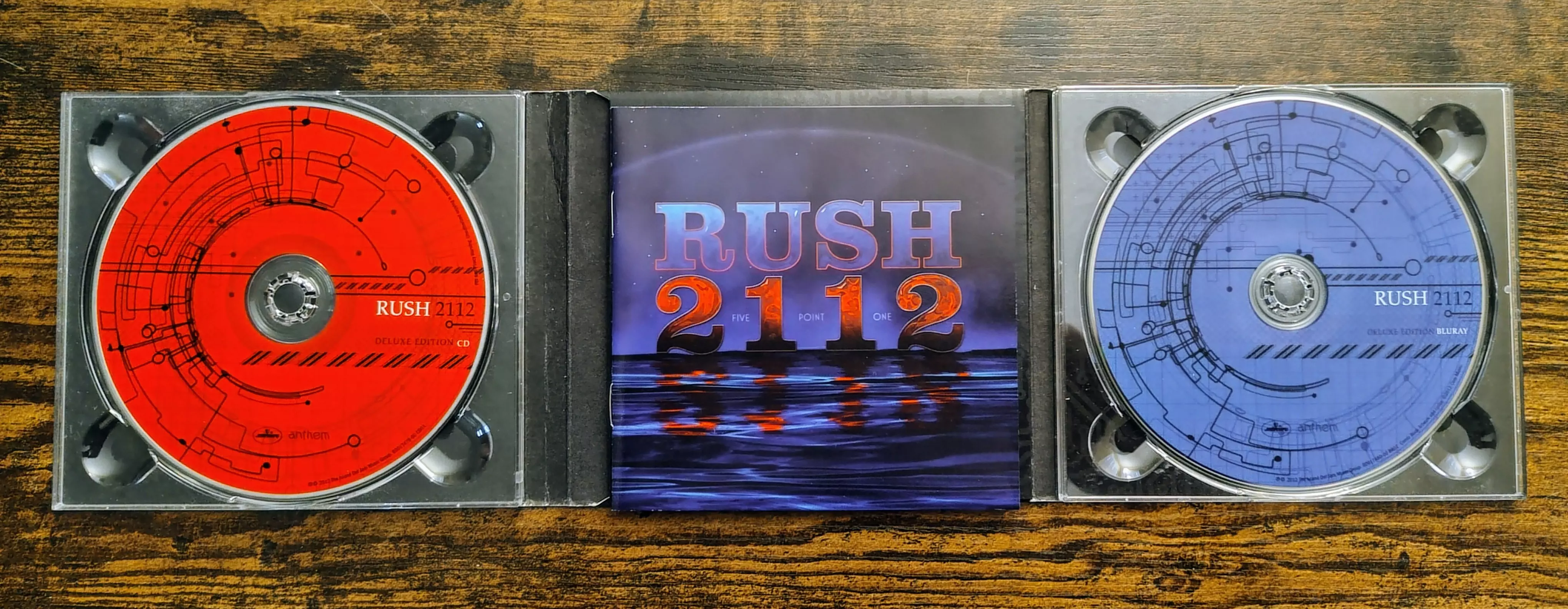 Rush 2112 5.1 remastered booklet spread showing the red and blue CDs