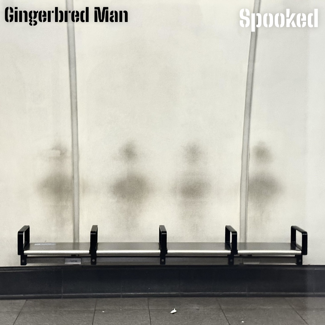 A fake album cover for 'Spooked' by Gingerbred Man, featuring a steel bench separated into four seats with arms rests against presumably a train or underground station wall, which has the ghostly after image from all the backs of people that have leaned against it.
